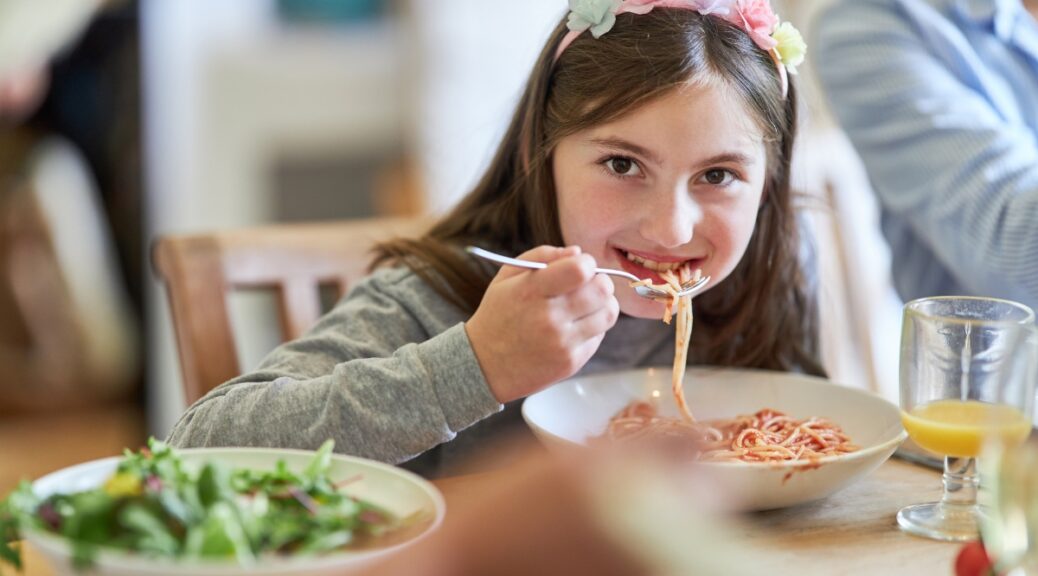 girl eating pasta