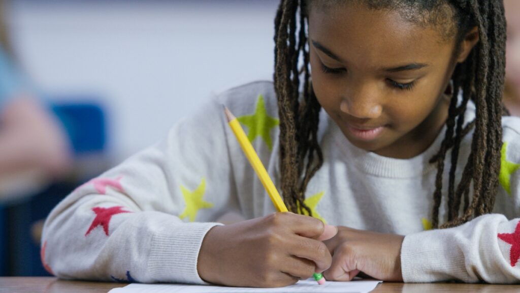 child testing pencil eraser